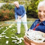 Senior Couple Raking Money in Yard