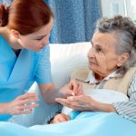 Nurse cares for a elderly woman lying in bed; Shutterstock ID 75178384; PO: aol; Job: production; Client: drone